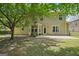 Spacious backyard with a basketball hoop and surrounded by mature trees at 826 Richmond Cir, Peachtree City, GA 30269