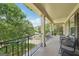 Spacious balcony offers seating, a black metal railing, and neighborhood views providing an ideal spot to relax outdoors at 826 Richmond Cir, Peachtree City, GA 30269