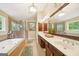 Bathroom featuring a jacuzzi tub, a glass-enclosed shower, and a double sink vanity with dark wood cabinets at 826 Richmond Cir, Peachtree City, GA 30269