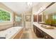 Bathroom featuring a jacuzzi tub, a glass-enclosed shower, and a double sink vanity with dark wood cabinets at 826 Richmond Cir, Peachtree City, GA 30269