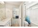 Bright bathroom with a tiled floor, white vanity, and shower-tub combo adjacent to a bedroom at 826 Richmond Cir, Peachtree City, GA 30269
