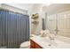 Well-lit bathroom with a chevron patterned shower curtain, modern vanity, and ample mirror space above the sink at 826 Richmond Cir, Peachtree City, GA 30269