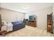 Bedroom with a bed, desk, and TV, great for relaxing or working, with lots of natural light from the window at 826 Richmond Cir, Peachtree City, GA 30269