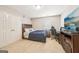 Cozy bedroom with a large TV, a bed with a blue comforter, and a desk area for study or work at 826 Richmond Cir, Peachtree City, GA 30269