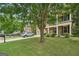 Well-maintained home featuring a lush green lawn, mature trees, and a welcoming front porch at 826 Richmond Cir, Peachtree City, GA 30269