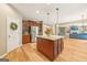 Modern kitchen with stainless steel appliances, island with granite countertop, and hardwood floors at 826 Richmond Cir, Peachtree City, GA 30269