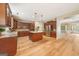 Spacious kitchen with dark wood cabinets, granite countertops, and an island with modern appliances at 826 Richmond Cir, Peachtree City, GA 30269