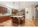 Beautiful kitchen with granite countertops, dark wood cabinets and a center island with bar stool seating at 826 Richmond Cir, Peachtree City, GA 30269