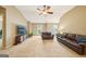 Comfortable living room with high ceilings, TV, and plush leather seating at 826 Richmond Cir, Peachtree City, GA 30269