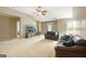 Large living room with plush leather seating, a TV, and neutral carpeting at 826 Richmond Cir, Peachtree City, GA 30269