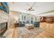 Bright living room with a fireplace, large sectional, and hardwood floors at 826 Richmond Cir, Peachtree City, GA 30269