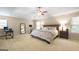 Bright main bedroom with a king bed, ceiling fan, and ample natural light at 826 Richmond Cir, Peachtree City, GA 30269