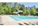 Large community pool with slides and lounge chairs, providing an inviting space for residents to relax and enjoy the sun at 826 Richmond Cir, Peachtree City, GA 30269