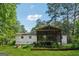 Spacious backyard view of a home with a screened in porch and a garden at 3123 Deshong Dr, Stone Mountain, GA 30087