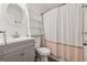 Well-lit bathroom with a shower-tub combo, large mirror and modern vanity at 3123 Deshong Dr, Stone Mountain, GA 30087