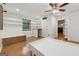 Large bedroom has lots of natural light, wood floors, and storage with a view to the kitchen at 3123 Deshong Dr, Stone Mountain, GA 30087