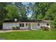 Charming single-story home featuring a well-manicured lawn and a quaint front porch at 3123 Deshong Dr, Stone Mountain, GA 30087