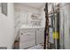 The laundry room with washer, dryer, water heater and shelves for plenty of storage at 3123 Deshong Dr, Stone Mountain, GA 30087