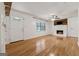 Bright living room with hardwood flooring, fireplace, and a traditional front door at 3123 Deshong Dr, Stone Mountain, GA 30087