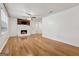 Spacious living room with hardwood floors and a charming fireplace with wood paneling at 3123 Deshong Dr, Stone Mountain, GA 30087