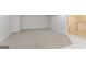 Neutral basement space with light carpet and an open doorway to a finished area at 5674 Mountain Cres, Stone Mountain, GA 30087