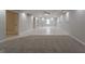 Large basement featuring a large carpeted area, tile flooring, tray ceilings and recessed lights at 5674 Mountain Cres, Stone Mountain, GA 30087