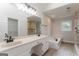 Bright bathroom with dual sink vanity, soaking tub, and glass-enclosed shower at 5674 Mountain Cres, Stone Mountain, GA 30087