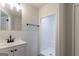 Clean bathroom featuring a walk-in shower with a bench, a modern vanity, and tiled walls at 5674 Mountain Cres, Stone Mountain, GA 30087