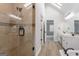 Hallway view of bathroom featuring a glass shower and a double sink vanity at 5674 Mountain Cres, Stone Mountain, GA 30087