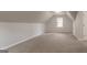 Bright bonus room featuring new carpet, recessed lighting and a window to let in natural light at 5674 Mountain Cres, Stone Mountain, GA 30087