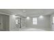 Bright bonus room showcasing tile flooring, recessed lighting, and glass paneled double doors at 5674 Mountain Cres, Stone Mountain, GA 30087