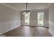 Elegant dining room with chandelier, wainscoting and hardwood floors at 5674 Mountain Cres, Stone Mountain, GA 30087