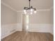 Bright dining room featuring hardwood floors, stylish chandelier, and attractive wainscoting at 5674 Mountain Cres, Stone Mountain, GA 30087