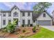 Charming two-story home with a well-manicured lawn and a two-car garage at 5674 Mountain Cres, Stone Mountain, GA 30087