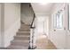 Foyer with staircase and white trim and an entryway door with glass at 5674 Mountain Cres, Stone Mountain, GA 30087
