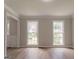 This is a photo of an empty living room with wood floor and two windows at 5674 Mountain Cres, Stone Mountain, GA 30087