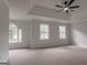 Large main bedroom with tray ceilings, a ceiling fan, large windows and plush carpeting at 5674 Mountain Cres, Stone Mountain, GA 30087