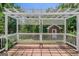 Backyard patio with a white pergola and view of a small building at 901 Chadwick Park Dr, Lawrenceville, GA 30045