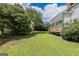 Backyard features lush lawn, mature trees, patio, and a shed at 901 Chadwick Park Dr, Lawrenceville, GA 30045