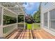 Backyard wooden patio with a white pergola, grass, and white siding at 901 Chadwick Park Dr, Lawrenceville, GA 30045
