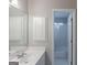 Well-lit bathroom featuring white cabinets and a shower-tub at 901 Chadwick Park Dr, Lawrenceville, GA 30045