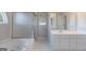 Bathroom featuring a large tub and white cabinetry at 901 Chadwick Park Dr, Lawrenceville, GA 30045