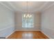 Charming dining room with hardwood floors, chandelier, and a large window at 901 Chadwick Park Dr, Lawrenceville, GA 30045
