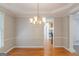 Open dining room with hardwood floors, a chandelier, and access to kitchen at 901 Chadwick Park Dr, Lawrenceville, GA 30045