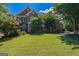 Traditional brick home with manicured lawn and mature trees and blue shutters at 901 Chadwick Park Dr, Lawrenceville, GA 30045