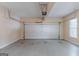 View of empty garage with roll-up door and overhead door mechanism at 901 Chadwick Park Dr, Lawrenceville, GA 30045