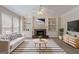 Cozy living room featuring a fireplace, built-in bookshelves, and modern decor at 901 Chadwick Park Dr, Lawrenceville, GA 30045