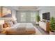 Comfortable primary bedroom suite featuring two windows, neutral walls, and tv at 901 Chadwick Park Dr, Lawrenceville, GA 30045