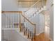 Beautiful staircase with wood railings and white spindles leading to the upper level at 901 Chadwick Park Dr, Lawrenceville, GA 30045