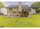 Back exterior of home with deck and concrete patio overlooking a spacious yard at 1006 Eagle Vw, Lawrenceville, GA 30044